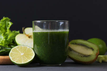 Green smoothie and fresh vegetables on the table for the detox organism