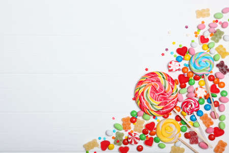 Candies and sweets on a colored background top view with place for text.の写真素材