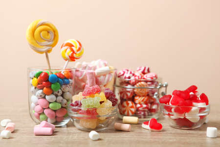various candy and sweets on the table on a colored background.の写真素材