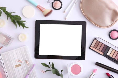 cosmetics and modern tablet on a colored background top view.の写真素材