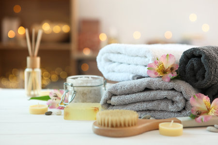 spa composition with towels and care products on the table with place for text.