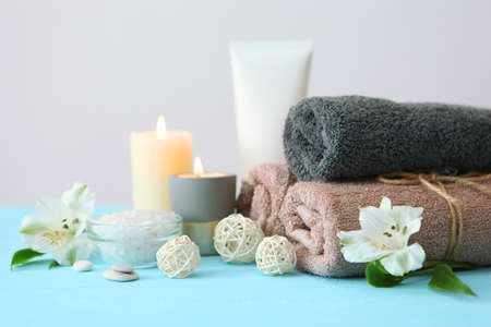 spa composition with towels and care products on the table with place for text.