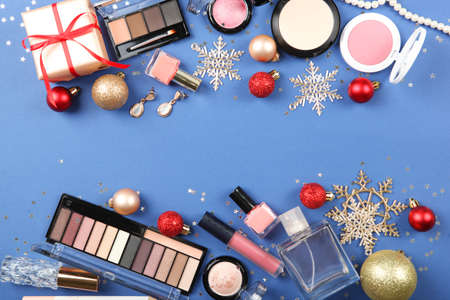 Beautiful composition with Christmas decor and makeup cosmetics top view.の写真素材
