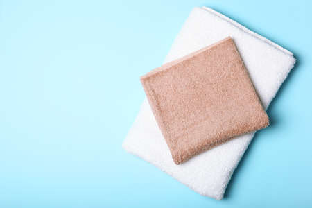 Fresh towels on a colored background with place for text top view.の写真素材
