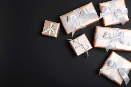 Gifts in gold packaging on a colored background with place for text.