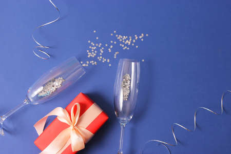 glasses and confetti on a colored background top view.の写真素材