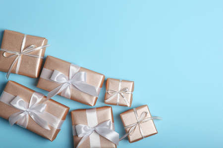 Gifts in gold packaging on a colored background with place for text.の写真素材