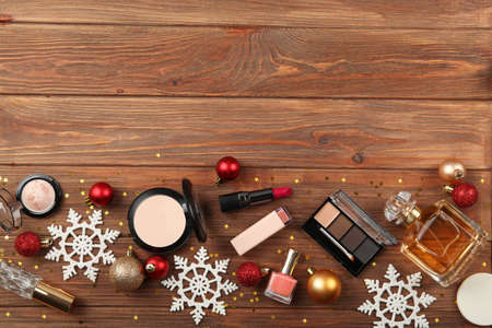 Beautiful composition with Christmas decor and makeup cosmetics top view.の写真素材