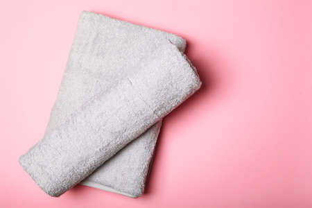 Fresh towels on a colored background with place for text top view.の写真素材