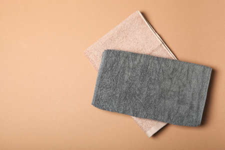 Fresh towels on a colored background with place for text top view.の写真素材