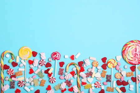 Candies and sweets on a colored background top view with place for text.