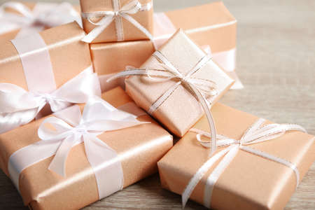 Gifts in gold packaging on a colored background with place for text.