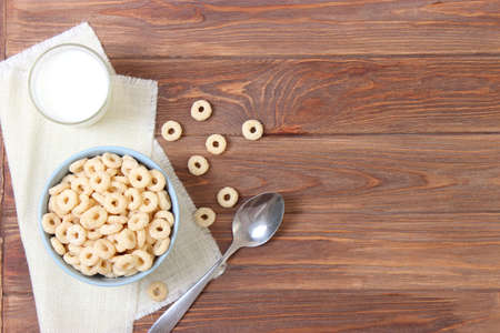 dry breakfast in a plate on a colored background top view. cereal