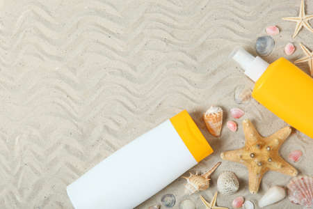 sand, shells, starfish and sun protection products.