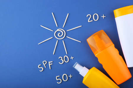Sunscreens on a colored background top view.の写真素材