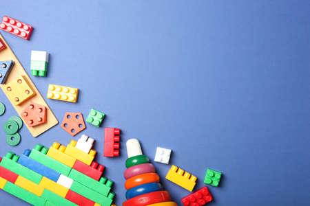 Set of different childrens toys on a colored background top view.