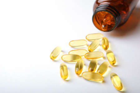 Omega 3 capsules on a white tableの写真素材
