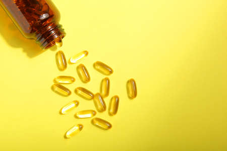 Omega 3 capsules on a colored background close-up with place for text.の写真素材