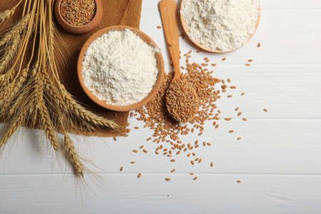 Wheat flour and spikelets of wheat on a light backgroundの写真素材