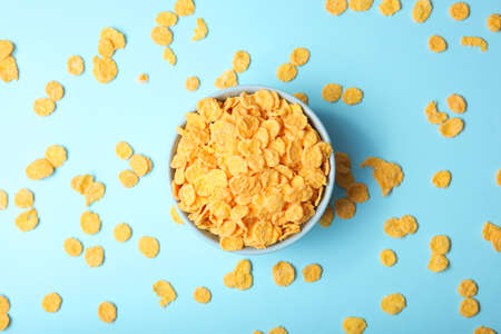 Delicious cornflakes in a plate against colored background.の写真素材
