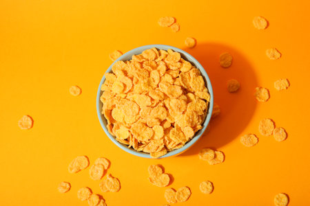 Delicious cornflakes in a plate against colored background.の写真素材