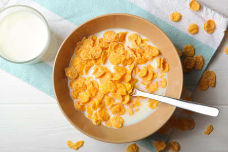 Crispy cornflakes with milk for breakfast on the table close-up.の写真素材