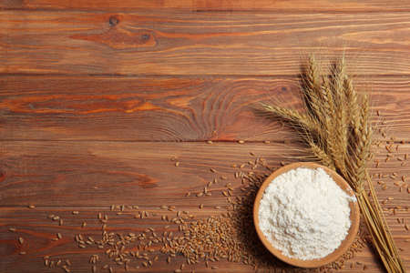 Wheat flour and spikelets of wheat on a light backgroundの写真素材