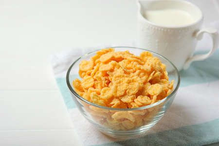 Crispy cornflakes with milk for breakfast on the table close-up.