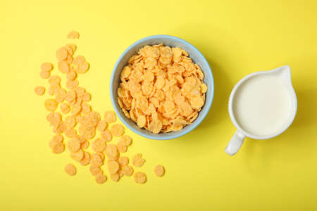 Golden and crunchy cornflakes on a colored background close-up
