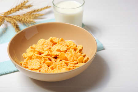 Crispy cornflakes with milk for breakfast on the table close-up.の写真素材