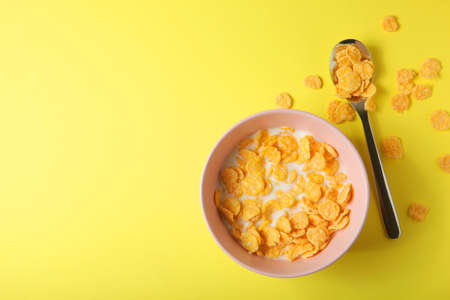 Crispy cornflakes with milk for breakfast on a colored background close-up.の写真素材
