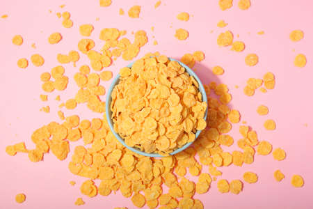 Delicious cornflakes in a plate against colored background.の写真素材