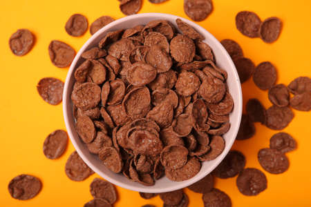 chocolate cornflakes for breakfast on colored background close upの写真素材