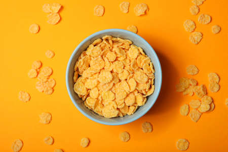 Golden and crunchy cornflakes on a colored background close-upの写真素材