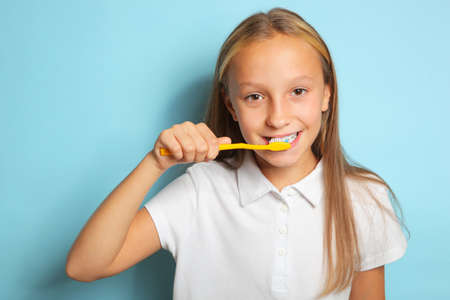 Girl in a good mood is brushing her teethの写真素材