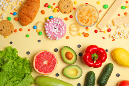 healthy foods and unhealthy foods on a colored background close-up top view.の写真素材