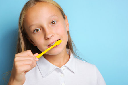 Girl in a good mood is brushing her teethの写真素材