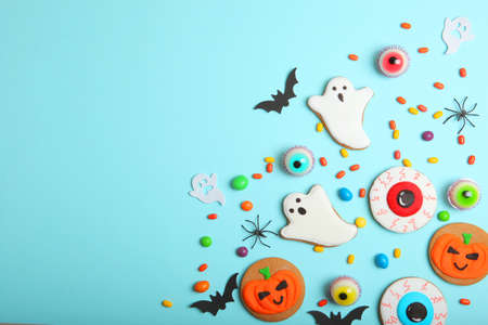 Halloween sweets on colored background close up top view with place for textの写真素材