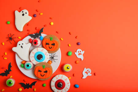 Halloween sweets on colored background close up top view with place for textの写真素材