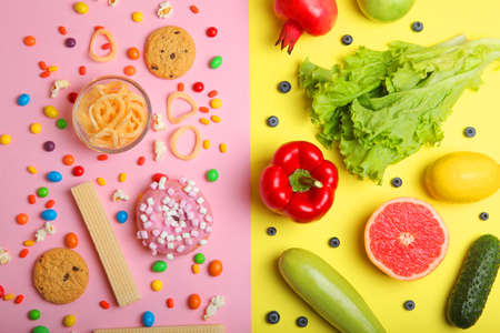 healthy foods and unhealthy foods on a colored background close-up top view.の写真素材
