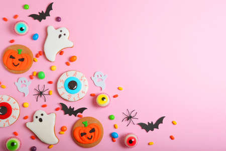 Halloween sweets on colored background close up top view with place for textの写真素材