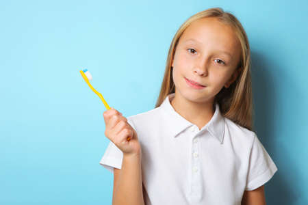 Girl in a good mood is brushing her teethの写真素材