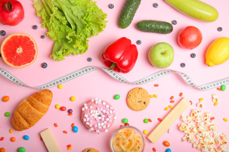 healthy foods and unhealthy foods on a colored background close-up top view.の写真素材