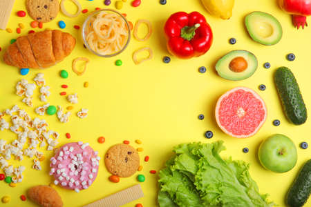 healthy foods and unhealthy foods on a colored background close-up top view.の写真素材