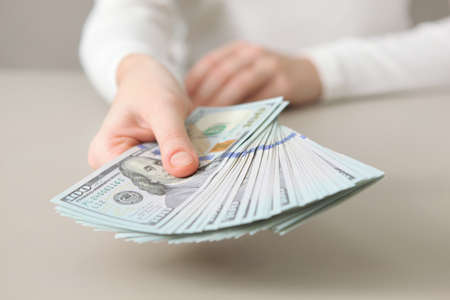 Many dollar bills in female hands close upの写真素材