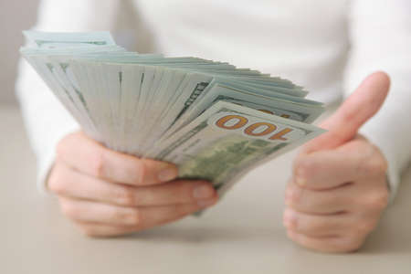 Many dollar bills in female hands close upの写真素材