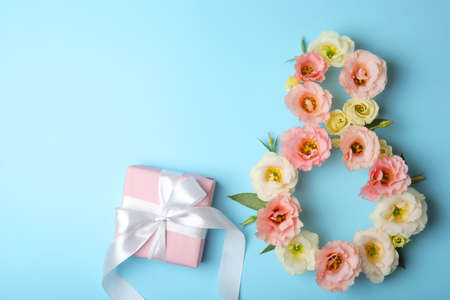 Flowers in the shape of number 8 on a colored background with place for text