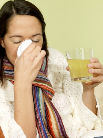 Young Woman with a Cold Blowing Noseの写真素材
