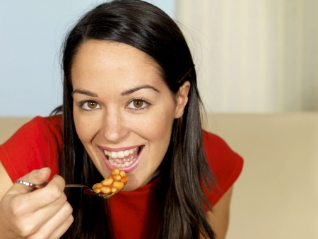 Young Woman Eating Baked Beansの写真素材