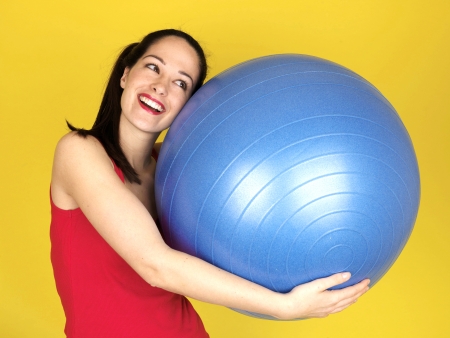 Young Woman Holding Swiss Fitness Ballの写真素材